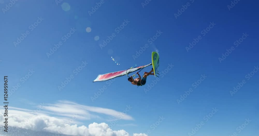 Windsurfer gets big air jumping off wave, Extreme sport Windsurfer gets big air jumping off wave, Extreme sport