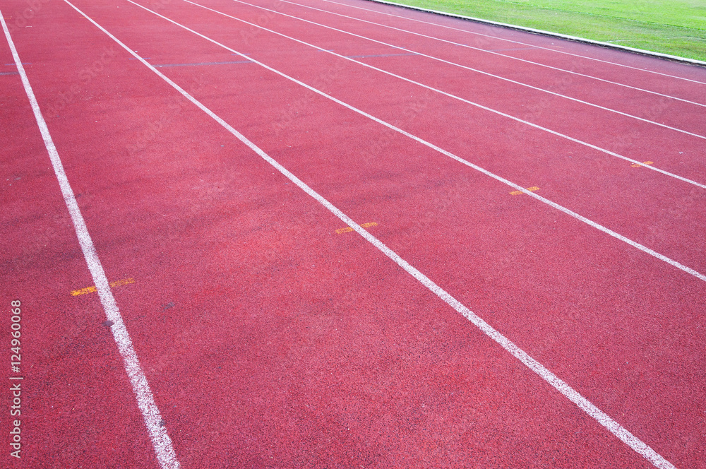 Fototapeta running track and green grass,Direct athletics Running track at Sport Stadium