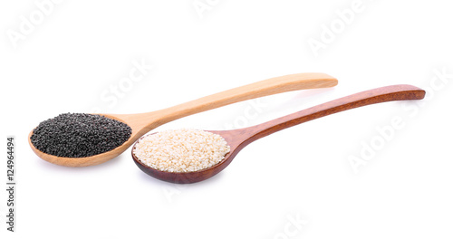 white and black sesame seeds in wooden spoon isolated on a white