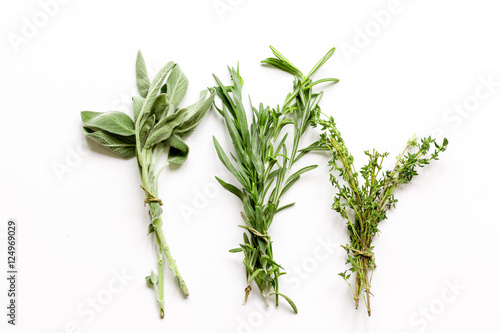 sage, rosemary, thyme - tufts of herbs white background