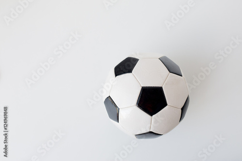 close up of football or soccer ball over white