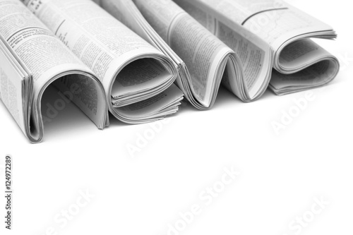 Folded modern newspapers. Concept of business news and print media photo