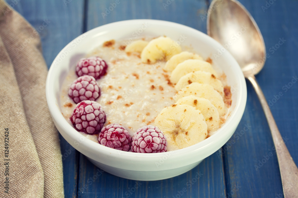 oatmeal with banana and berries on white dish oatmeal with banana and berries on white dish