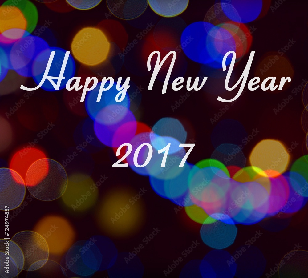 Card with Happy New Year 2017 writing on multicolor light bokeh. New Year 2017 card. Card with Happy New Year 2017 writing on multicolor light bokeh. New Year 2017 card.