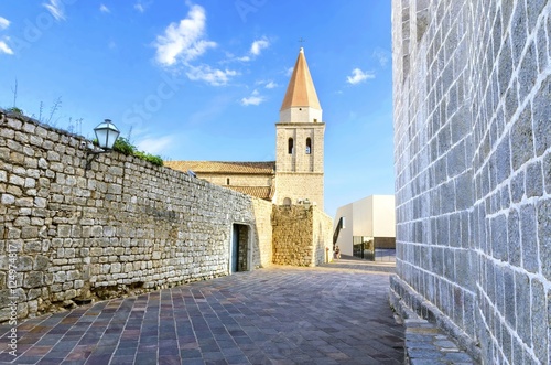 Pyramidal tower of the Church of our Lady of Health,Romanesque cathedral formely named St Michael the archangel, basilica at the Square of The Glagolitic housed monasteries on Krk island, in Croatia. photo