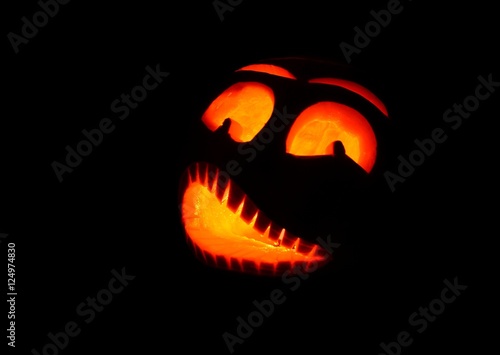 Shining scary halloween pumpkin face at night. © Hamik