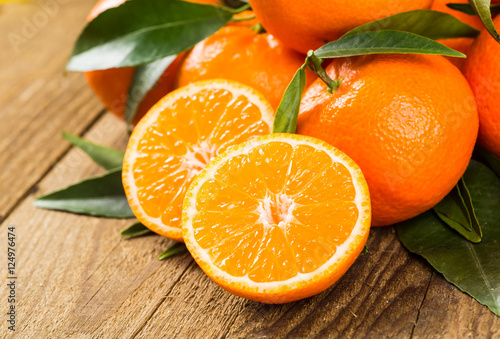 Konstfotografi Ripe Mandarin fruit peeled open and place on old rustic look tim