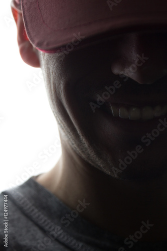 Portrait of a young man in cap smile, front view photo