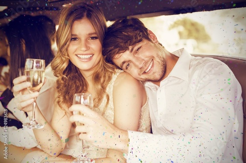 Composite image of portrait of couple holding champagne