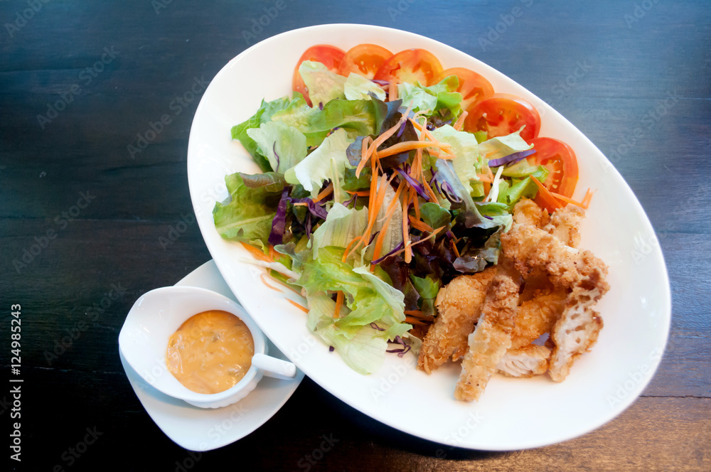 Breaded chicken with salad ,soft focus