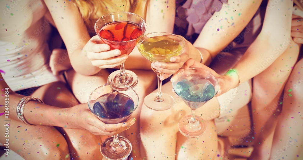 Fototapeta premium Composite image of girls with cocktails toasting