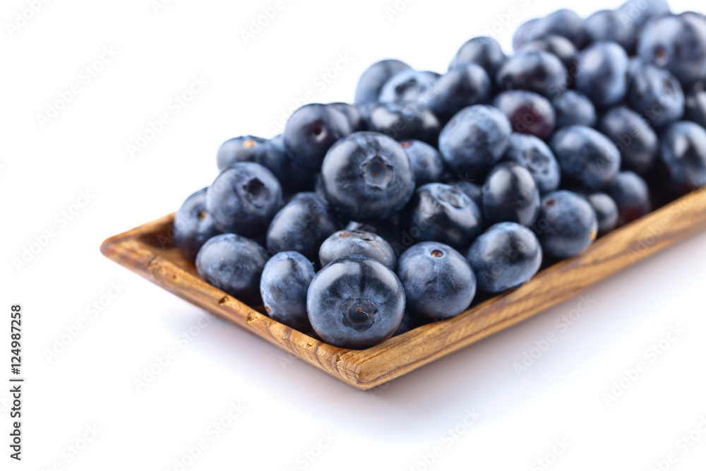 blueberries in wooden dish isolated on white blueberries in wooden dish isolated on white