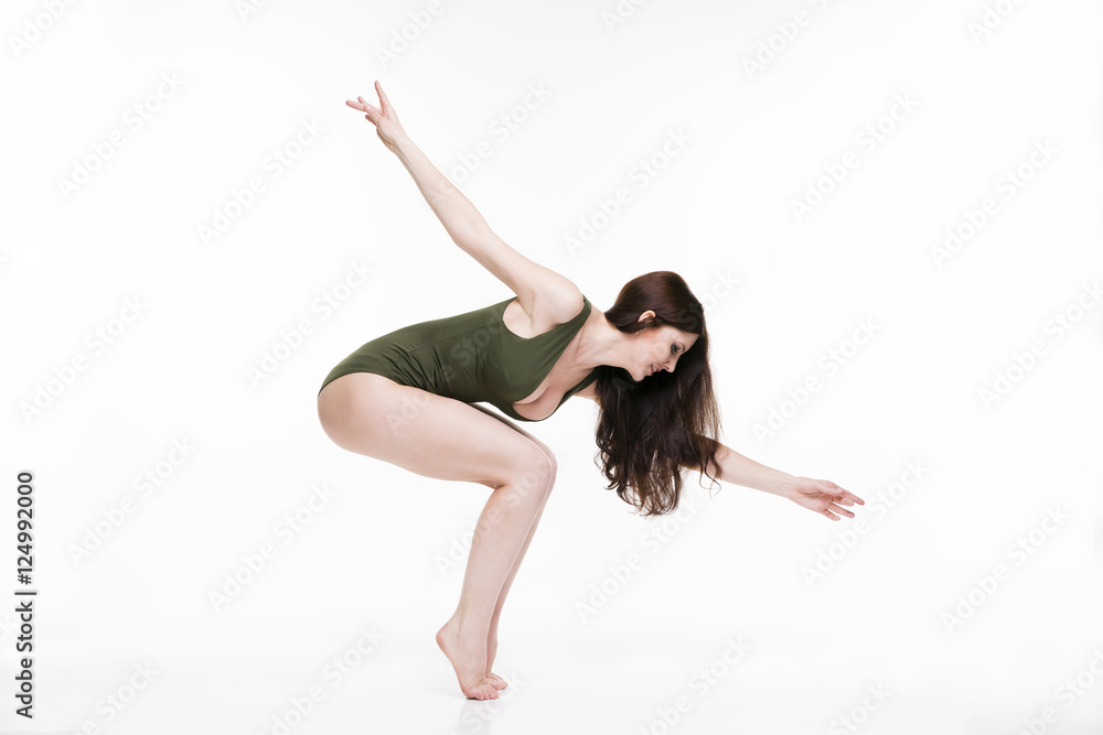 Young beautiful caucasian woman dancing in studio on white background Young beautiful caucasian woman dancing in studio on white background