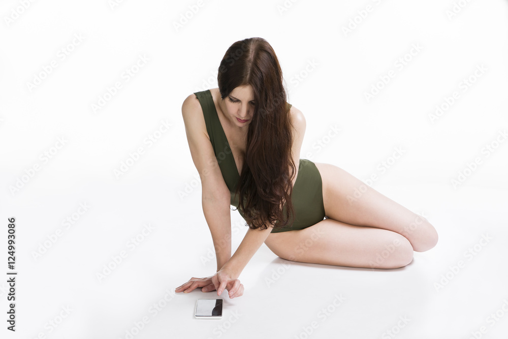 Young beautiful caucasian woman with mobile phone in studio on white background Young beautiful caucasian woman with mobile phone in studio on white background