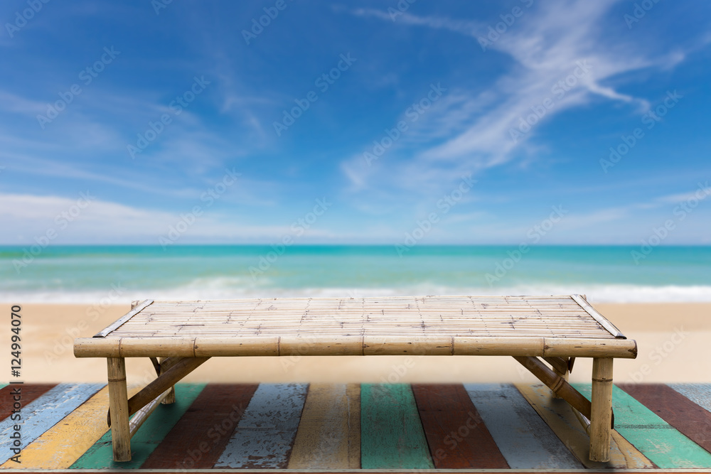 Fototapeta premium Wooden bamboo sunbeds on old wood ,beautiful beach and sea