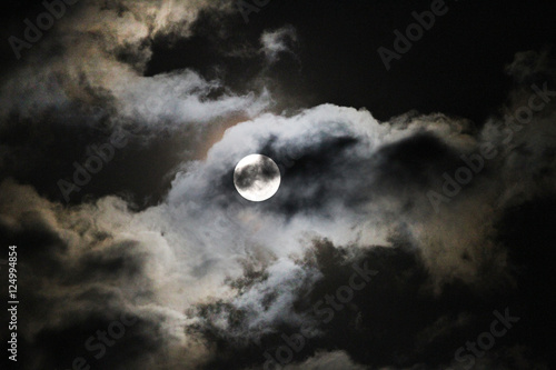 Full Hunter's Moon with clouds, eerie or spooky full moon for Halloween or fall photo