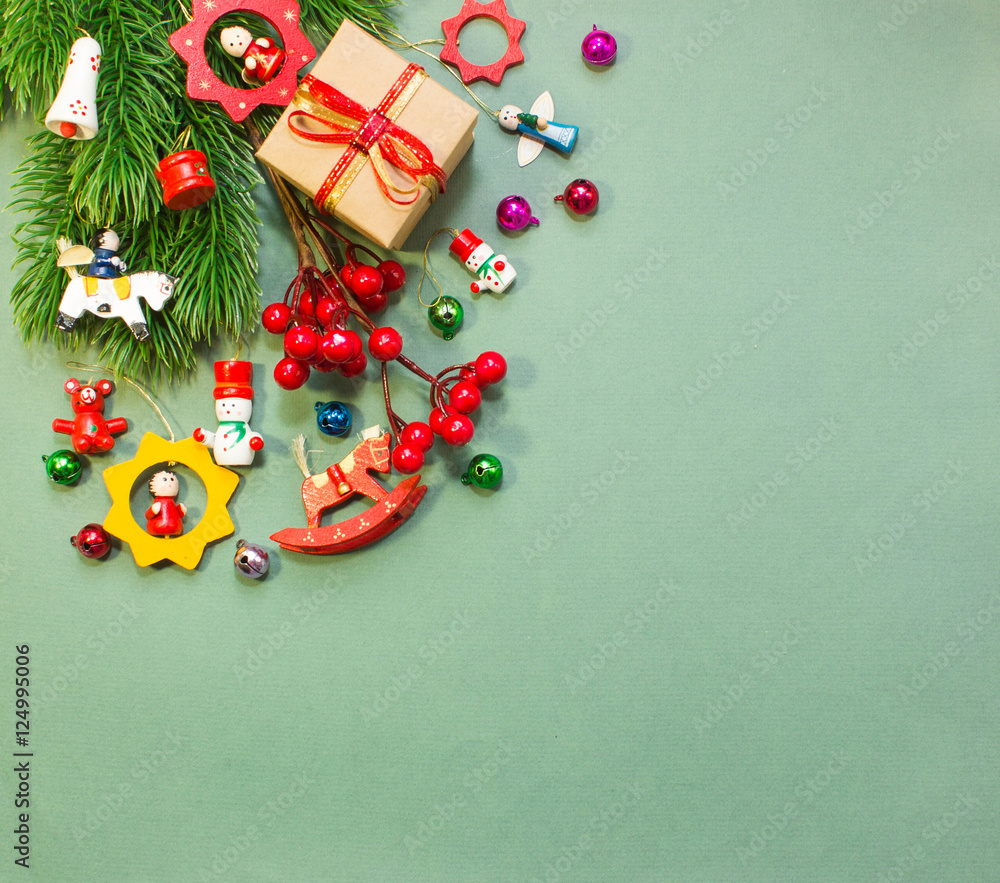 Christmas or New Year background: wooden toys, fur-tree, gifts, decoration on green background Christmas or New Year background: wooden toys, fur-tree, gifts, decoration on green background