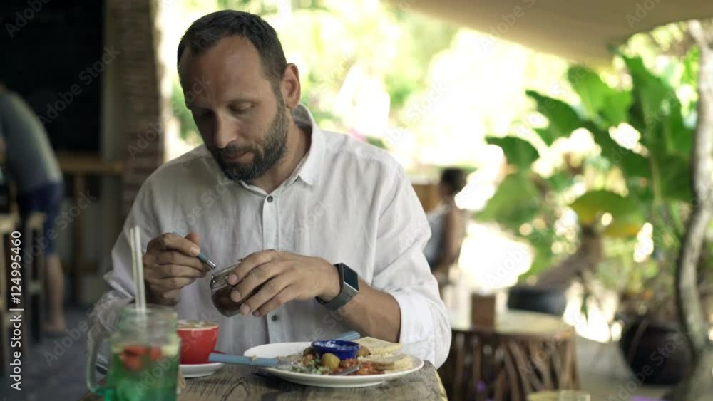 Young man adding brown sugar to coffee during breakfast, 4K
Young man adding brown sugar to coffee during breakfast, 4K