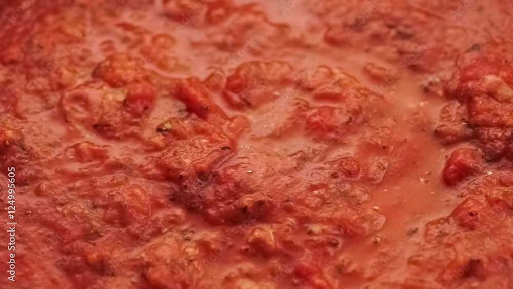 Flavorful Italian pasta sauce simmering as it cooks, macro slow motion Flavorful Italian pasta sauce simmering as it cooks, macro slow motion