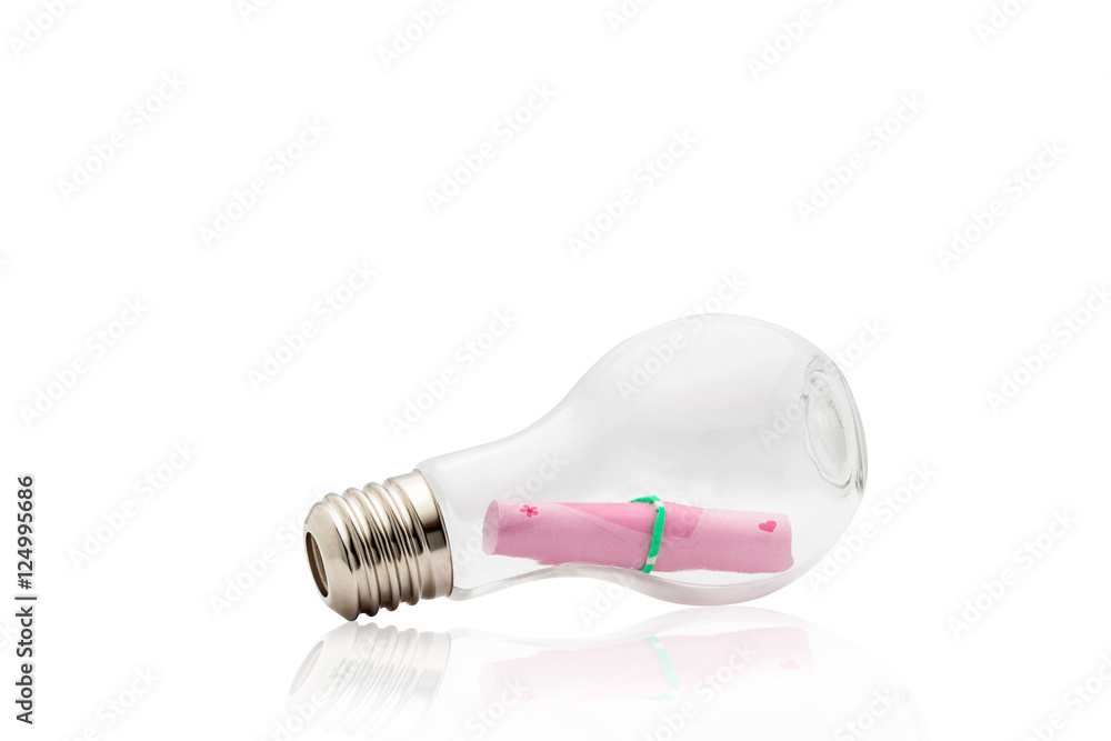 Light bulb with pink paper note inside isolated on white backgro Light bulb with pink paper note inside isolated on white backgro