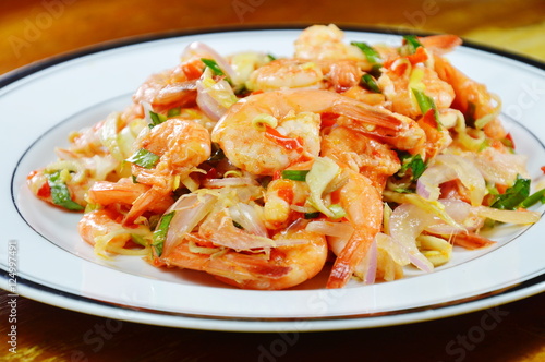 spicy prawn with herb salad on plate