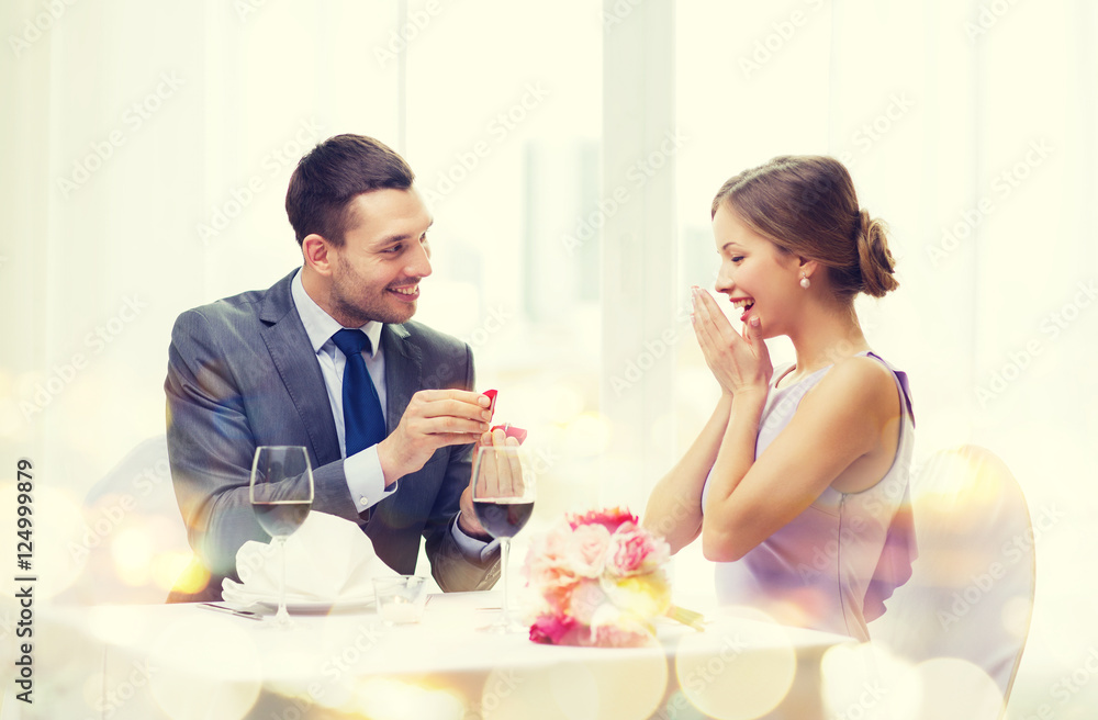man proposing to his girlfriend at restaurant man proposing to his girlfriend at restaurant