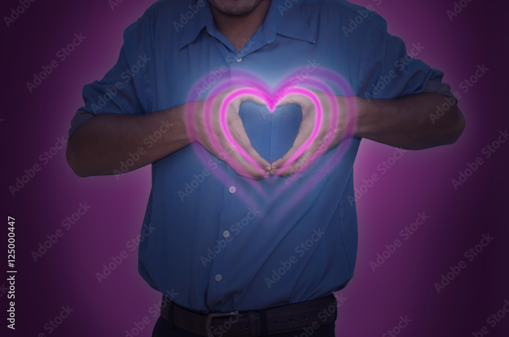 happy man making heart sign with hands and pink background happy man making heart sign with hands and pink background