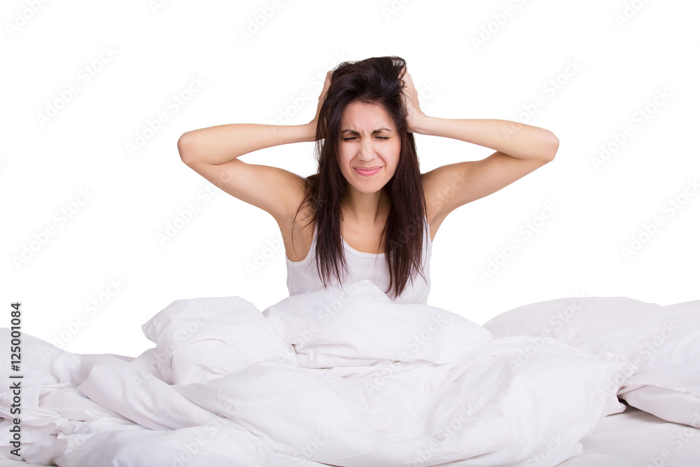 Portrait of young female in the morning with alarm clock. Woman does not want to wake up. Isolated Portrait of young female in the morning with alarm clock. Woman does not want to wake up. Isolated