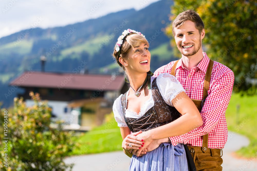 Paar In Tracht Steht Auf Alm In Den Alpen Stock Photo Adobe Stock