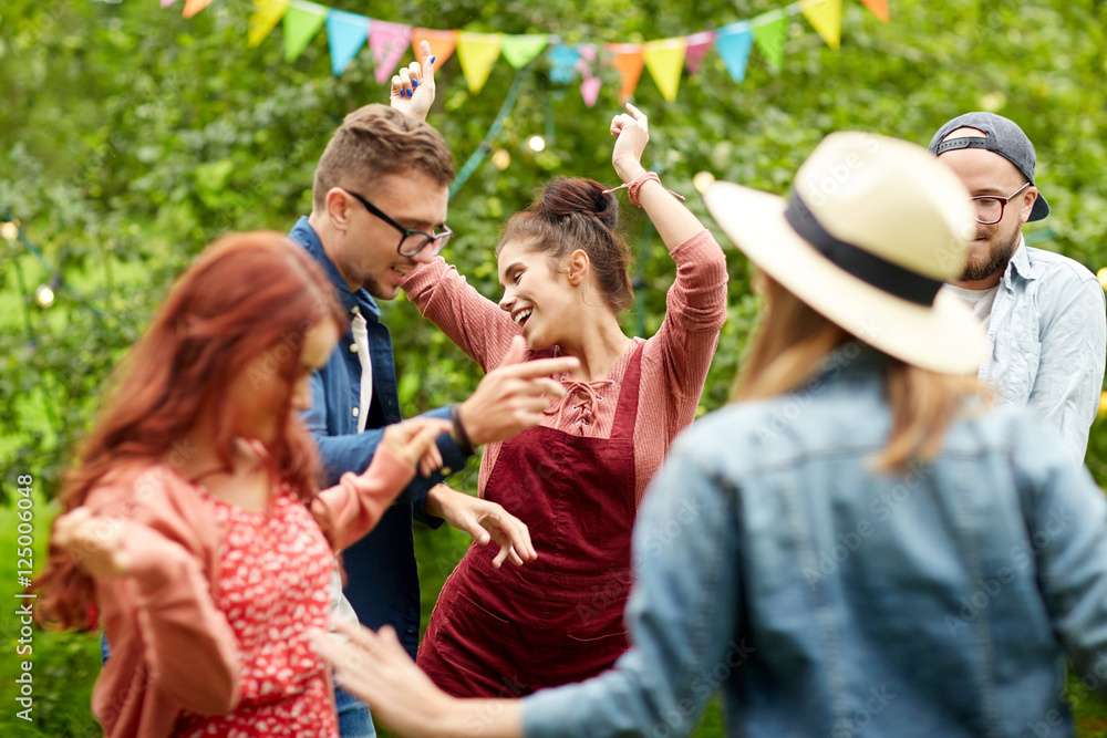 happy friends dancing at summer party in garden happy friends dancing at summer party in garden