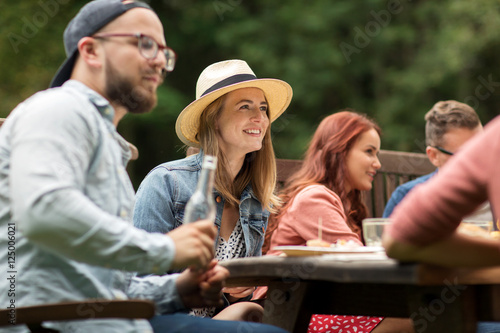 happy friends having dinner at summer garden party