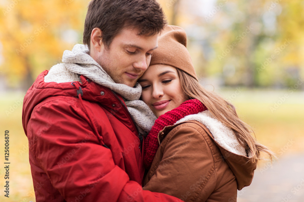 Fototapeta premium close up of happy couple hugging in autumn park
