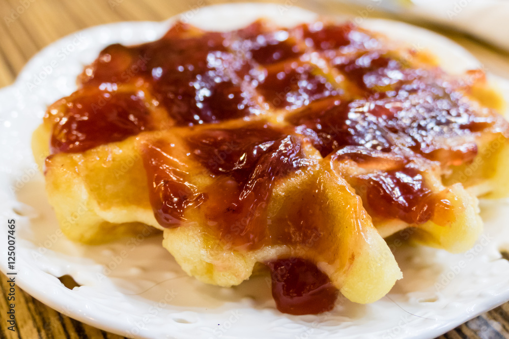 Fresh Belgian liege waffle with strawberry jam Fresh Belgian liege waffle with strawberry jam