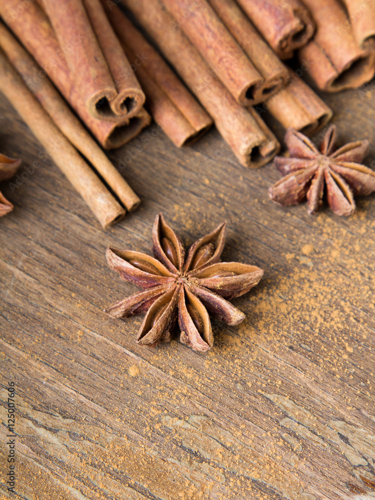 cinnamon sticks and star anise on wooden background cinnamon sticks and star anise on wooden background