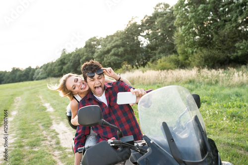 Couple in love enjoying a quad bike ride in countryside.