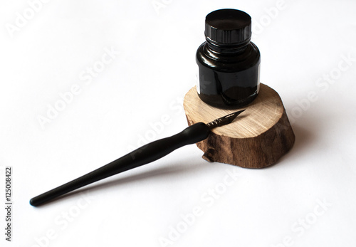 old ink pen and ink bottle isolated on white bakground