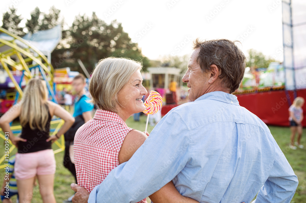 Senior couple having a good time at the fun fair
