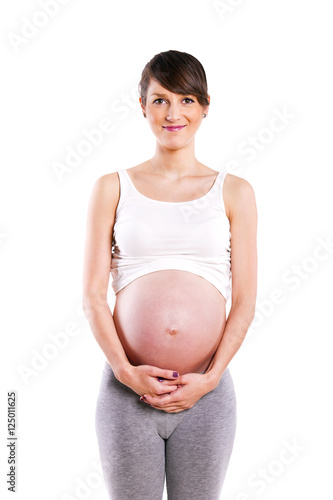 Beautiful pregnant woman - isolated over a white background..