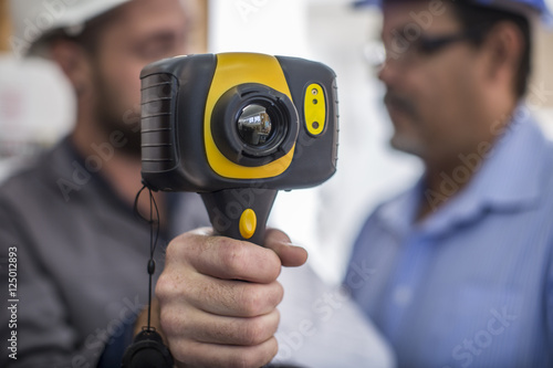 Electrician holding thermal imaging camera
