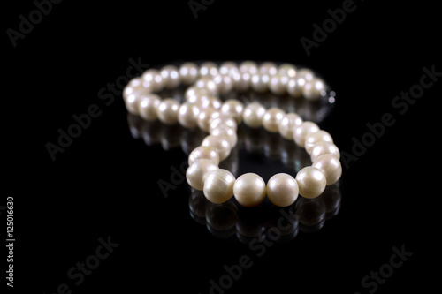 String of pearls on black background