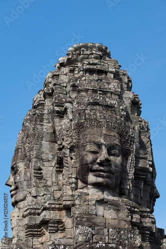 Smiling gargantuan face at Angkor Thom Siem Reap Cambodia.