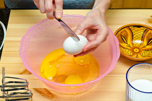 Making cookies. Chacking eggs. photo