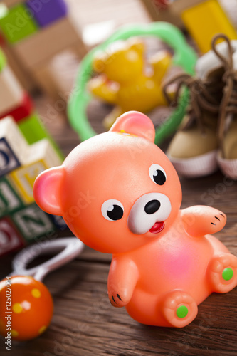 Colorful children toys on wooden background