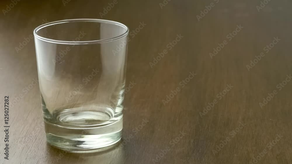 Empty drinking glass filling up with a stream of fruity blackcurrant flavored juice with copyspace, slow motion 30p Empty drinking glass filling up with a stream of fruity blackcurrant flavored juice with copyspace, slow motion 30p