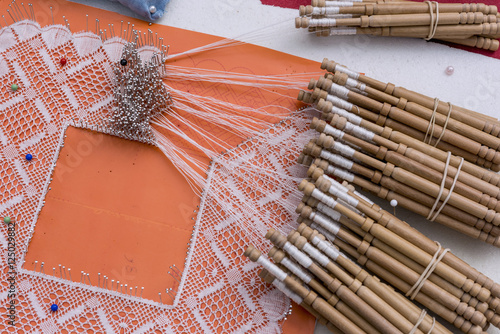 Close-up of artisanal manufacturing tatting. Bobbin lace manufacturing photo