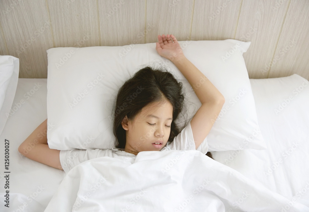 Portrait of happy young Asian girl with long black hair sleeping in bed at home. Portrait of happy young Asian girl with long black hair sleeping in bed at home.