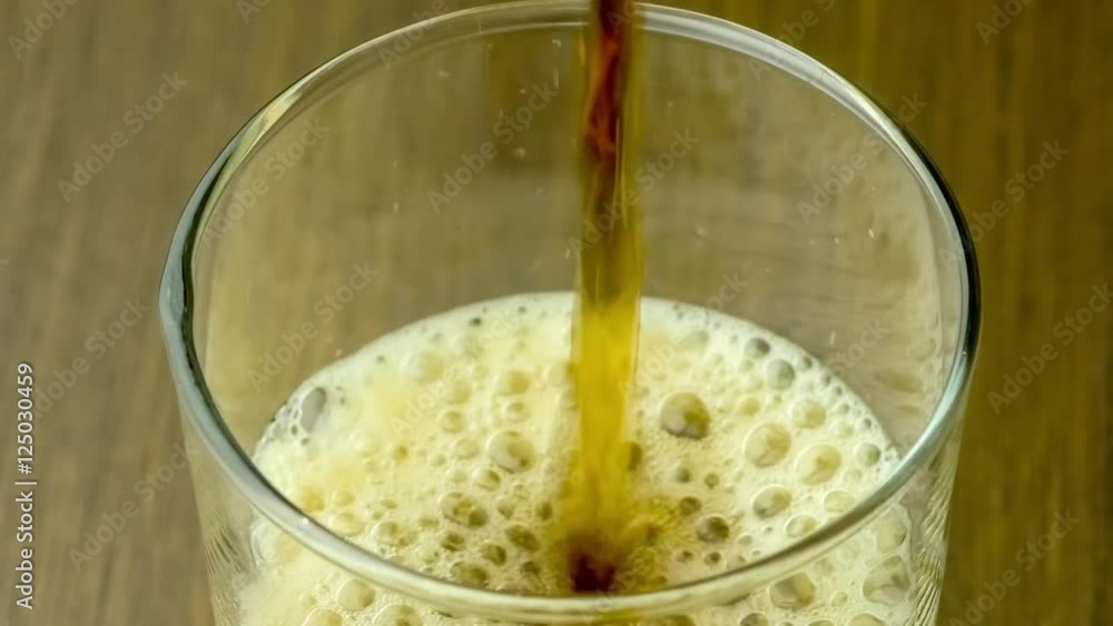 Detailed close up soda soft drink pouring into glass cup forming carbonated bubbles that foam and pop includes sound, 4K 30p Detailed close up soda soft drink pouring into glass cup forming carbonated bubbles that foam and pop includes sound, 4K 30p