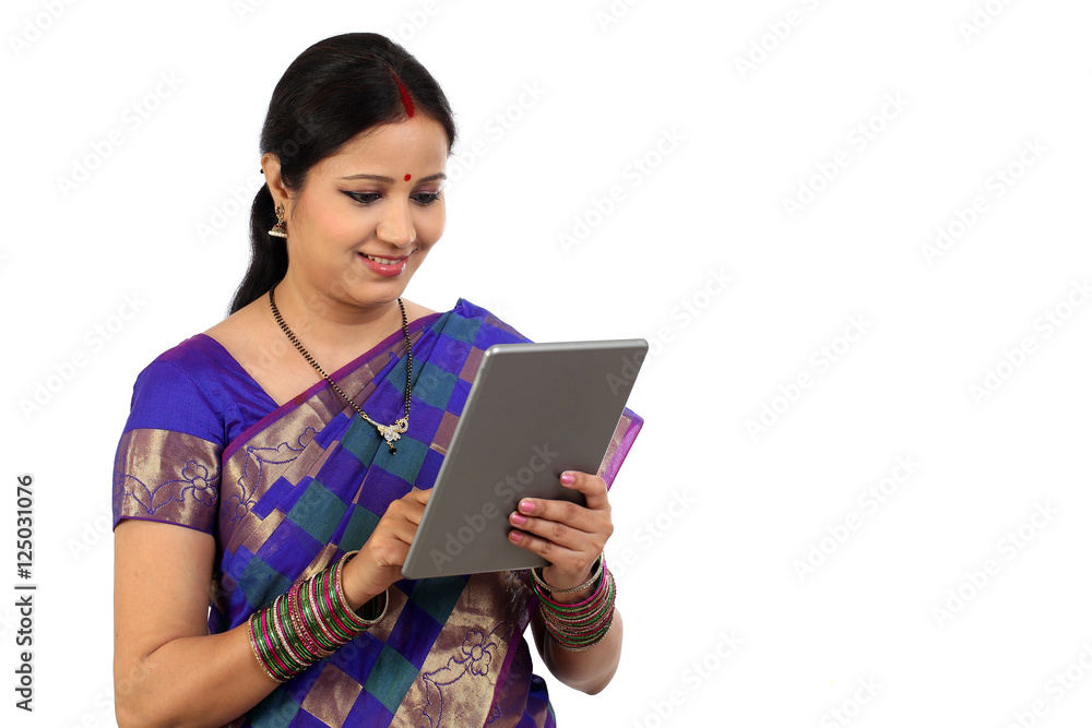 Traditional Indian housewife using tablet computer Traditional Indian housewife using tablet computer