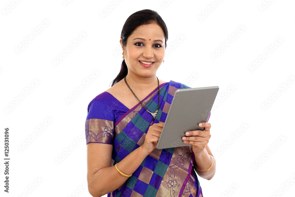 Traditional Indian woman using tablet computer at home Traditional Indian woman using tablet computer at home