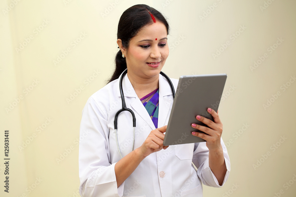 Traditional young female doctor holding tablet computer Traditional young female doctor holding tablet computer
